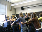 Classroom rehearsal, showing masked students in synchronized choreography.